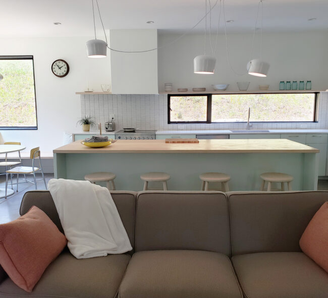 White open concept kitchen with mint accents and featuring an eat in bar and breakfast nook